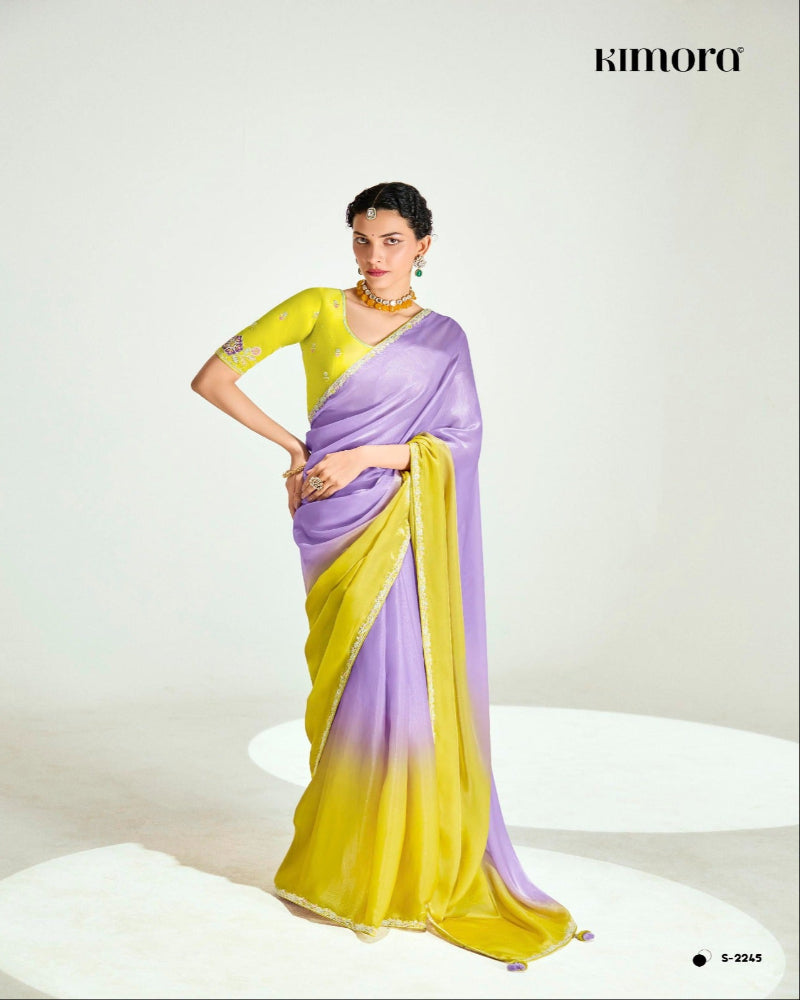 Woman wearing a yellow and purple saree with a white background