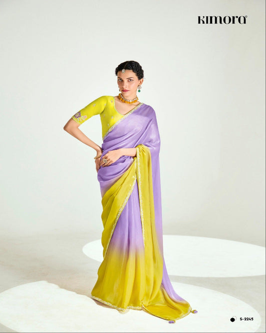 Woman wearing a yellow and purple saree with a white background