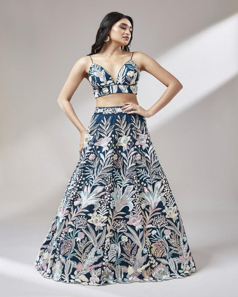 Woman wearing a floral two-piece outfit on a plain background