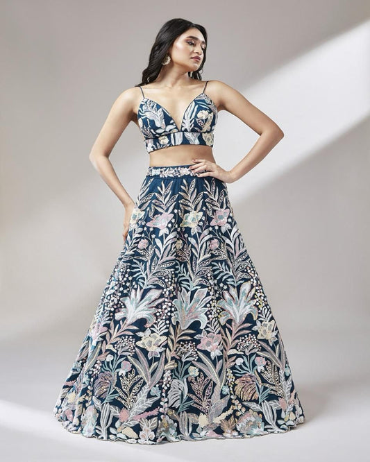 Woman wearing a floral two-piece outfit on a plain background