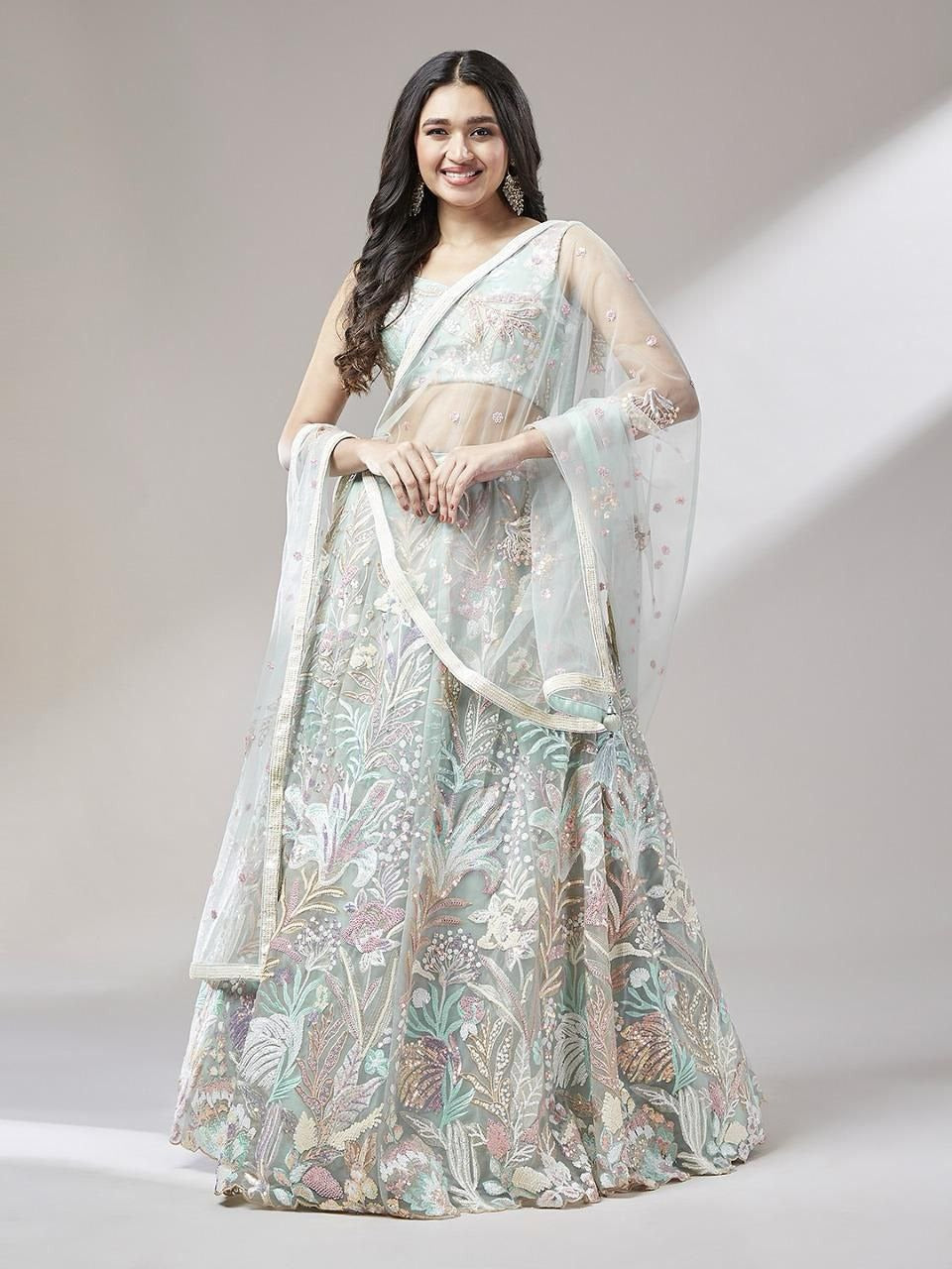 Woman wearing a floral saree with a plain background