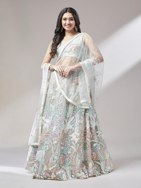 Woman wearing a floral saree with a plain background